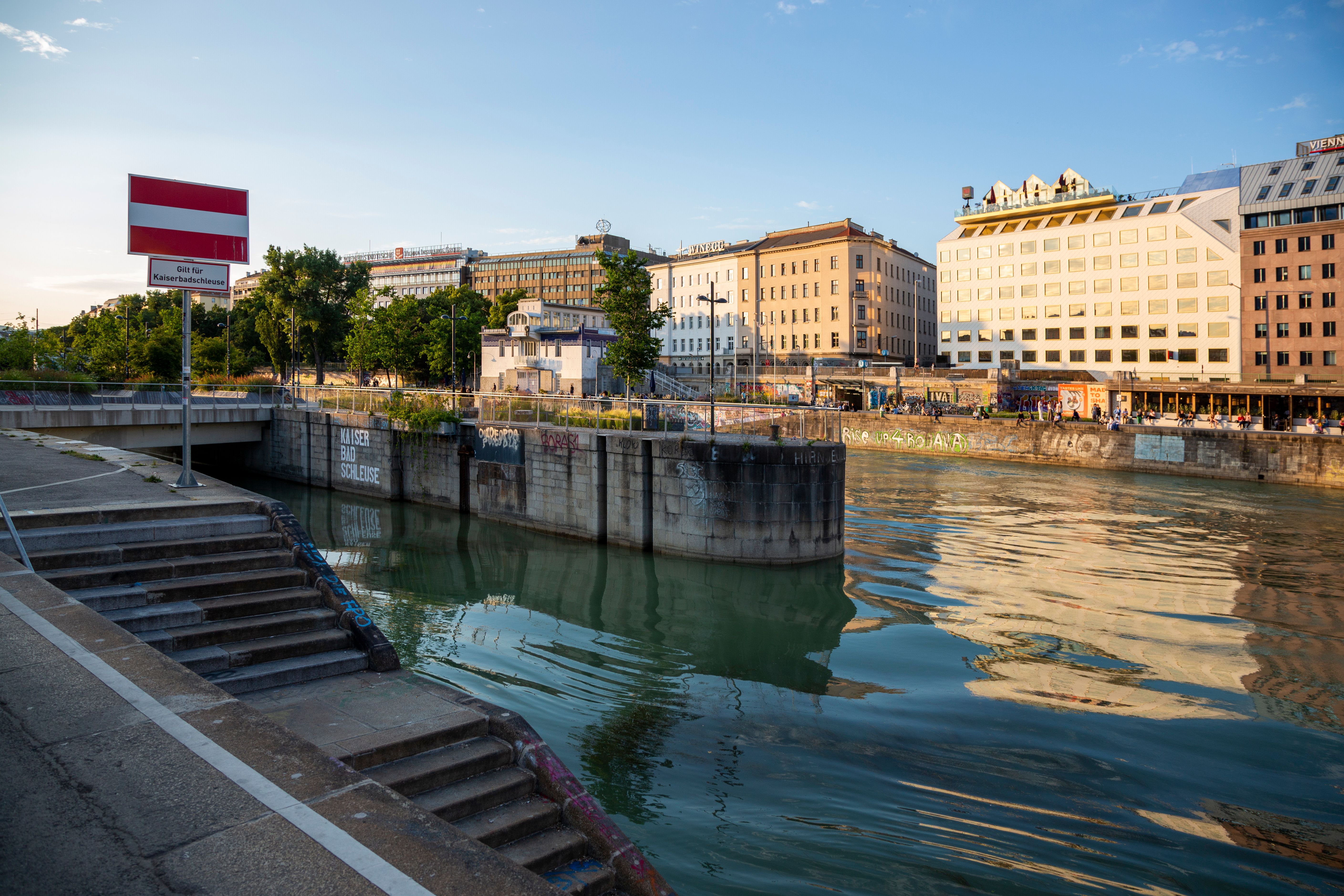 Vienna's Danube Canal at sunset with historic architecture reflected in the water
