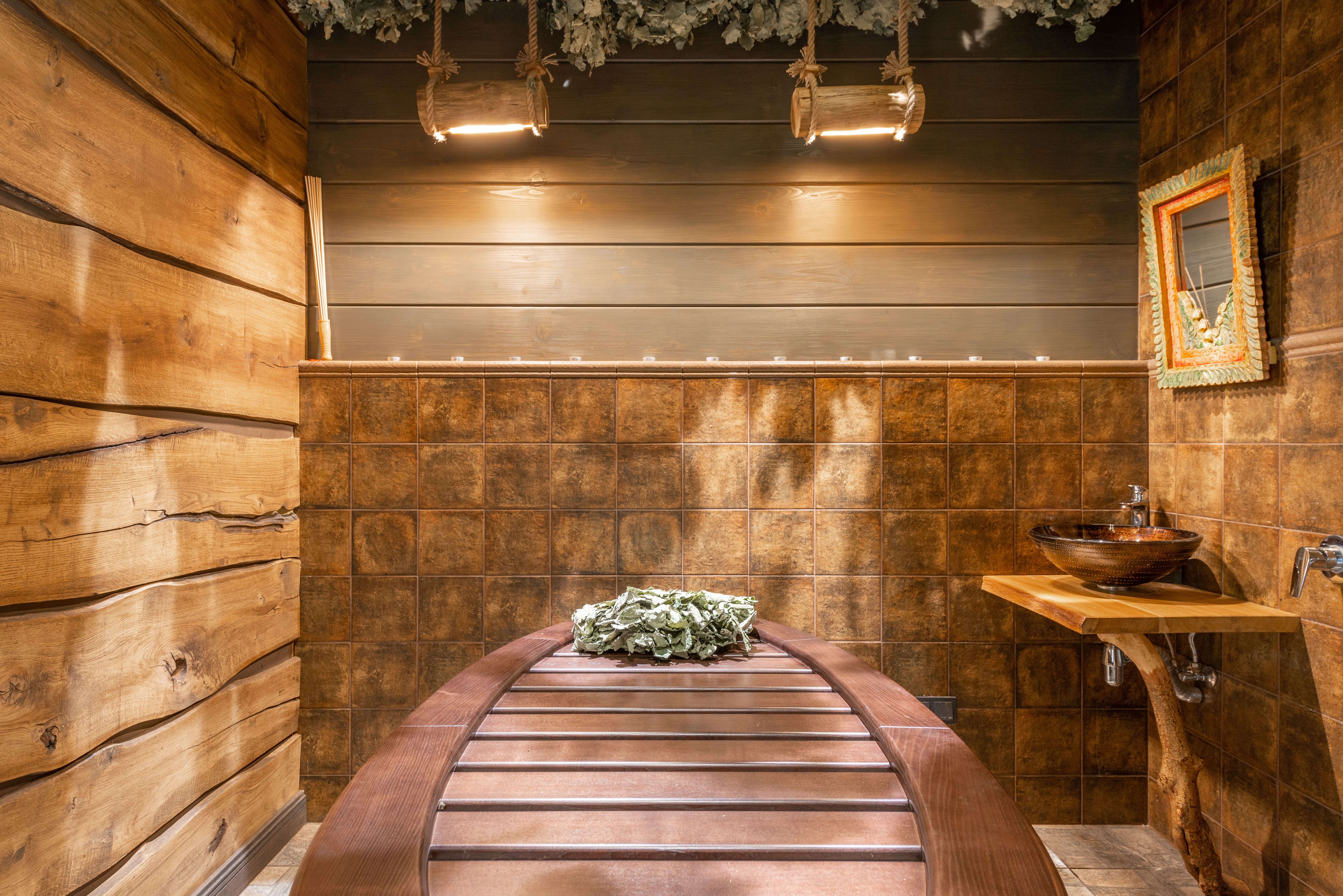 Cozy rustic sauna interior with warm wood accents and natural decor.